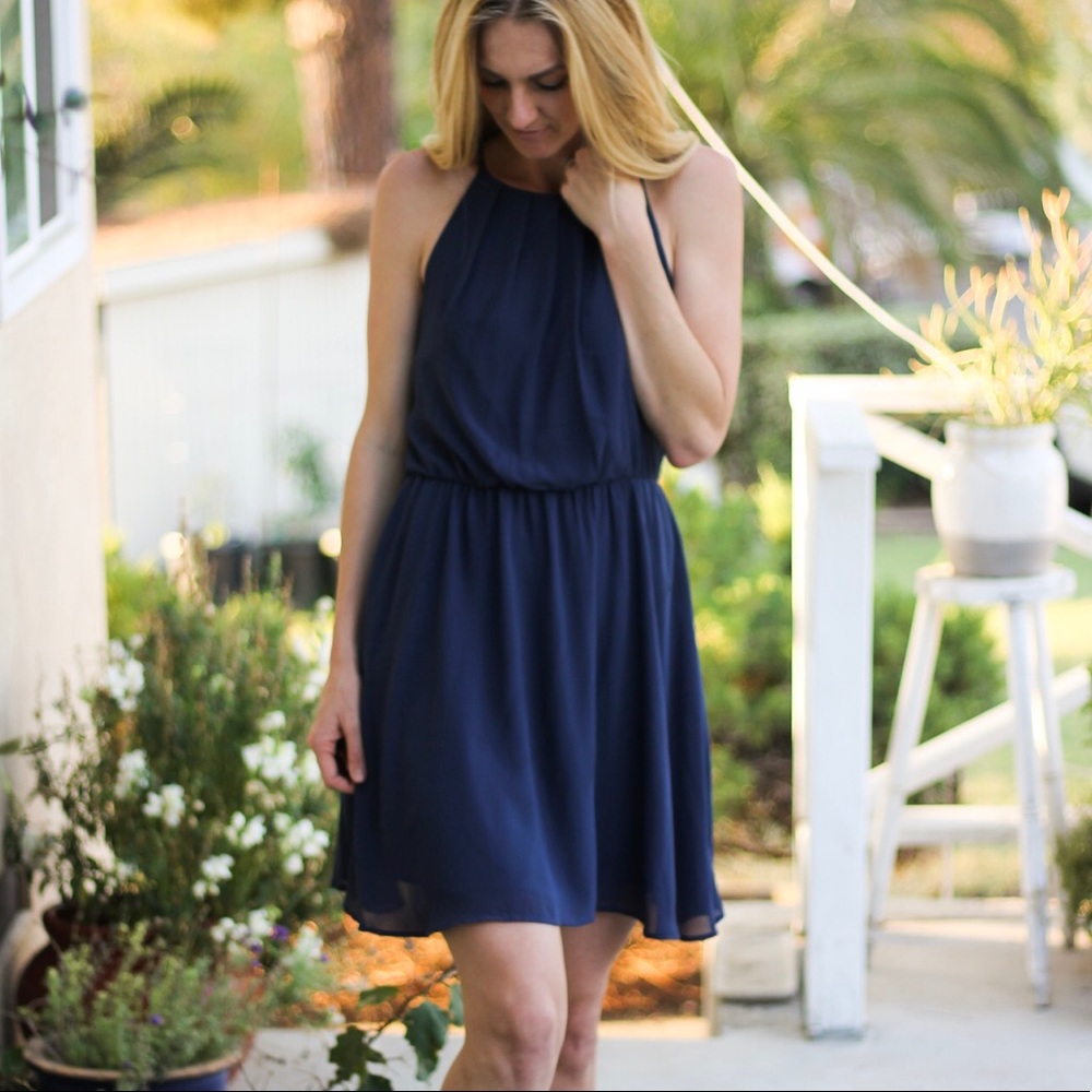 Navy high-neck, tuck-waisted mini dress.